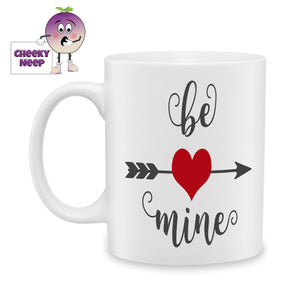White ceramic mug with a large red heart on an arrow with the word "Be" printed above the arrow and "Mine" printed below as produced by Cheekyneep.com