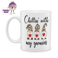 White ceramic mug with three gnomes holding red hearts and the words 