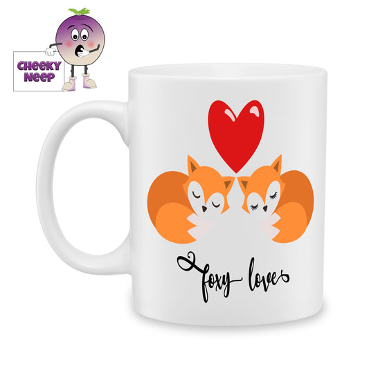 White ceramic mug with a large red heart above two foxes and the words "Foxy Love" as produced by Cheekyneep.com