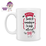 white ceramic mug with the words "Happy (Thanks for reminding me I'm single with a cat) Day" printed on the mug. Mug as produced by Cheekyneep.com