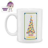 White ceramic mug with a picture of a christmas tree made up of coloured hearts and the words Merry Christmas printed on the mug. As produced by Cheekyneep.com