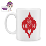 white ceramic mug with a red arabesque and inside the picture are the words "Hello Valentine" and a picture of heart. Mug as produced by Cheekyneep.com