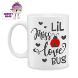 white ceramic mug with a picture of a lady bug and the words "Lil Miss Love Bug" printed on the mug. Mug as produced by Cheekyneep.com
