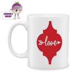 white ceramic mug with a red arabesque shape with the words Love and an arrow printed in the shape. Mug as produced by Cheekyneep.com