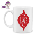 white ceramic mug with a red arabesque shape and the word "love" printed in the middle of the shape. Mug as produced by Cheekyneep.com