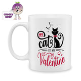 white ceramic mug with the words "My cat is my valentine" together with a picture of a cat printed on the mug. Mug as produced by Cheekyneep.com