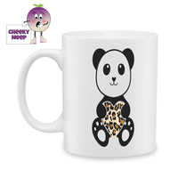 white ceramic mug with a picture of a panda holding a leopard print heart. Mug as produced by Cheekyneep.com