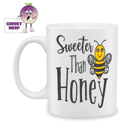 white ceramic mug with a picture of a bee and the words "Sweeter than Honey" printed on the mug. Mug as produced by Cheekyneep.com