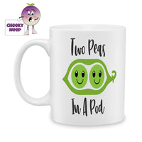 white ceramic mug with a picture of two peas in a pod and the words 