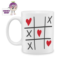 white ceramic mug with a picture of a knots and crosses game where the knots have been replaced by red love hearts. Mug as produced by Cheekyneep.com