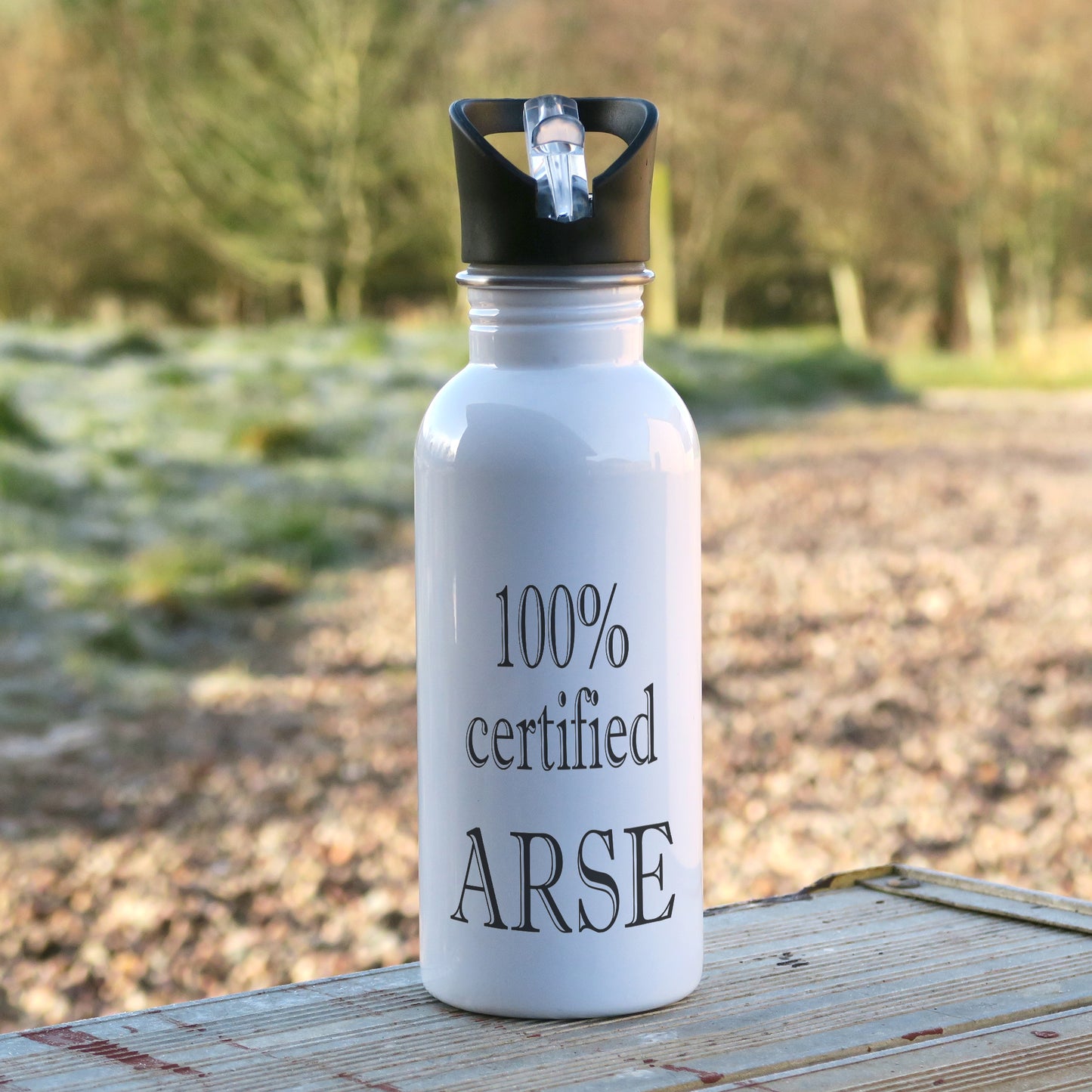 600ml white aluminium sports water bottle with the words "100% certified Arse" written in black text on the bottle