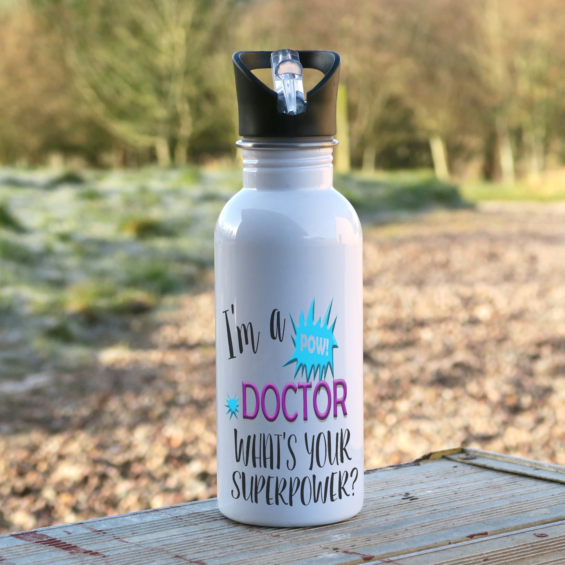 600ml white aluminium white sports water bottle with the words "I'm a doctor what's your superpower?" printed on the bottle