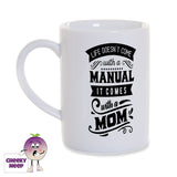 White porcelain mug with the words "Life doesn't come with a manual it comes with a mom" printed in black on the mug as produced by Cheekyneep.com
