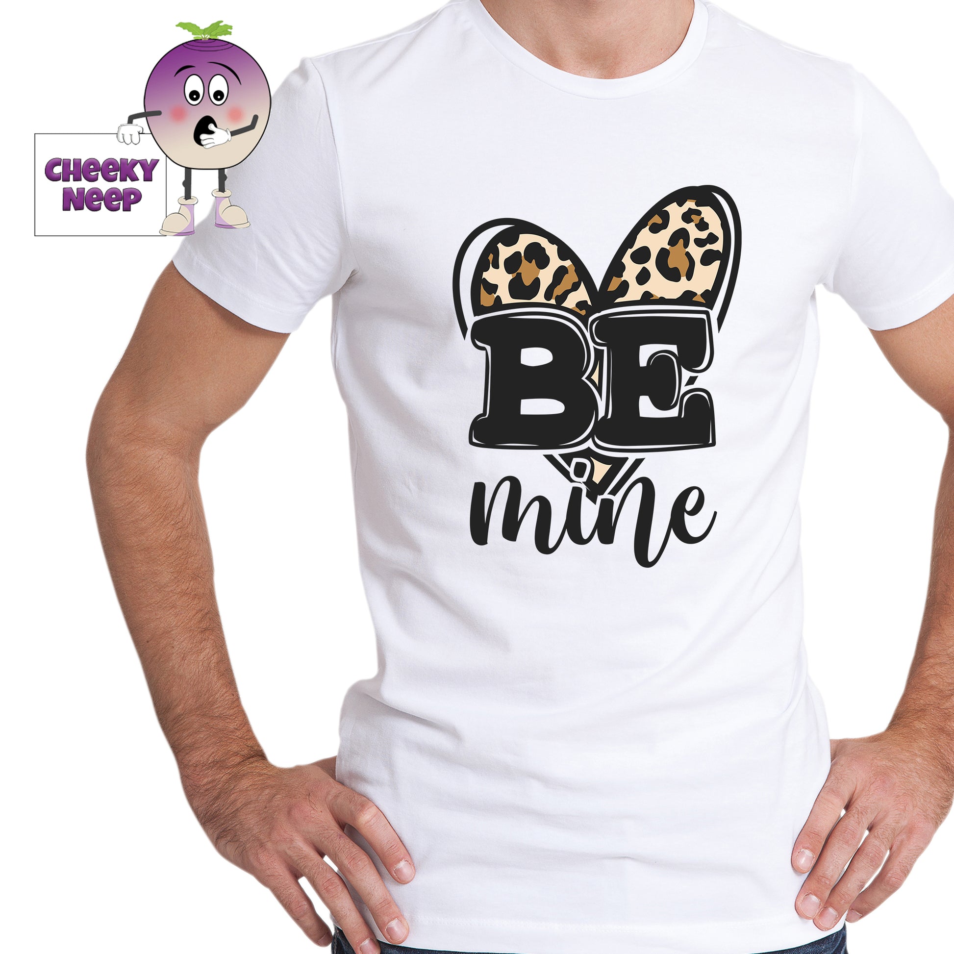 Man in a white tee with the slogan "Be Mine" printed in front of a leopard print heart shape on the tee. Tee as produced by Cheekyneep.com