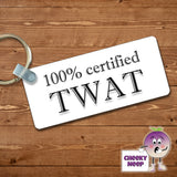 Rectangular plastic keyring with the words "100% certified Twat" printed on both sides.