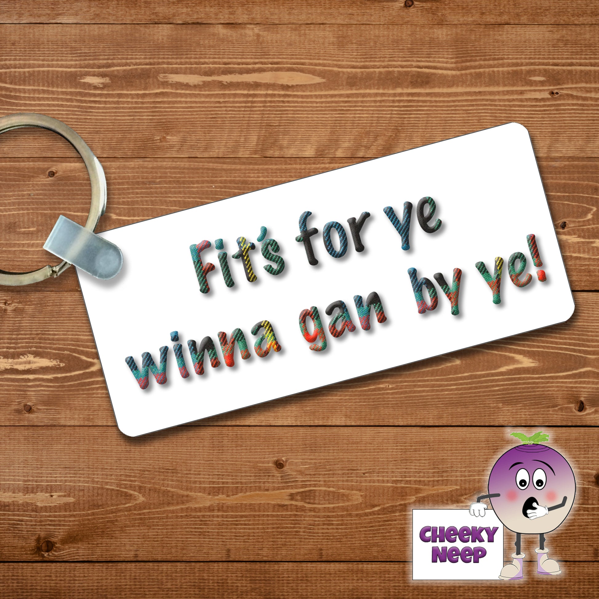 Rectangular plastic keyring with the words "Fit's For Ye Winna Gan By Ye!" printed in tartan on both sides.