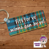 Rectangular plastic keyring with the words "Fit's For Ye Winna Gan By Ye!" printed in white on a tartan background on both sides.