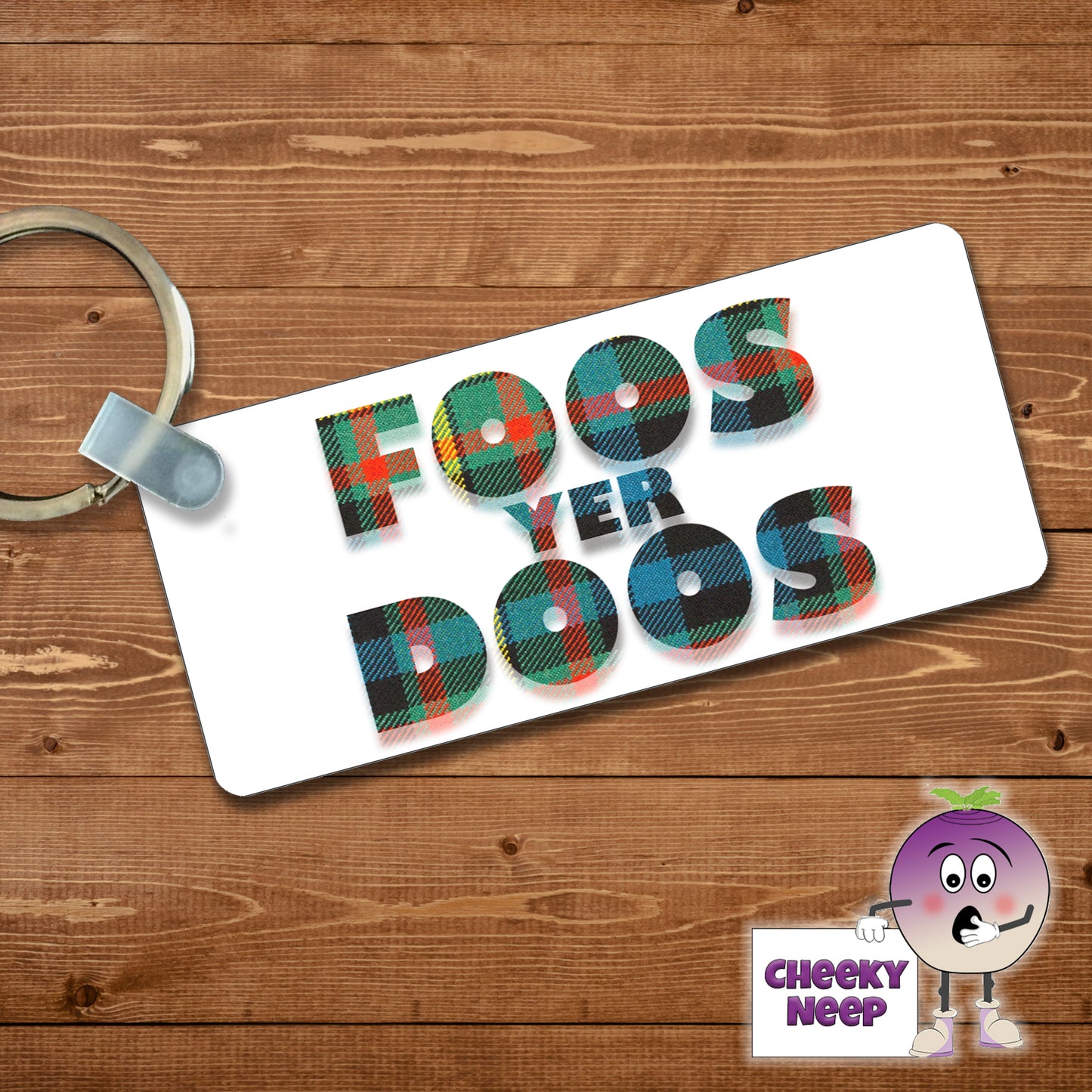 Rectangular plastic keyring with the words "Foos Yer Doos" printed in green tartan on both sides.