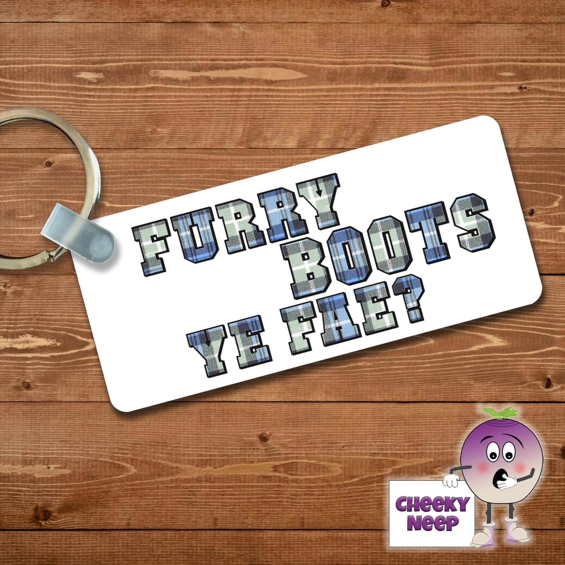 Rectangular plastic keyring with the words "Furry Boots Ye Fae?" printed in tartan on both sides.