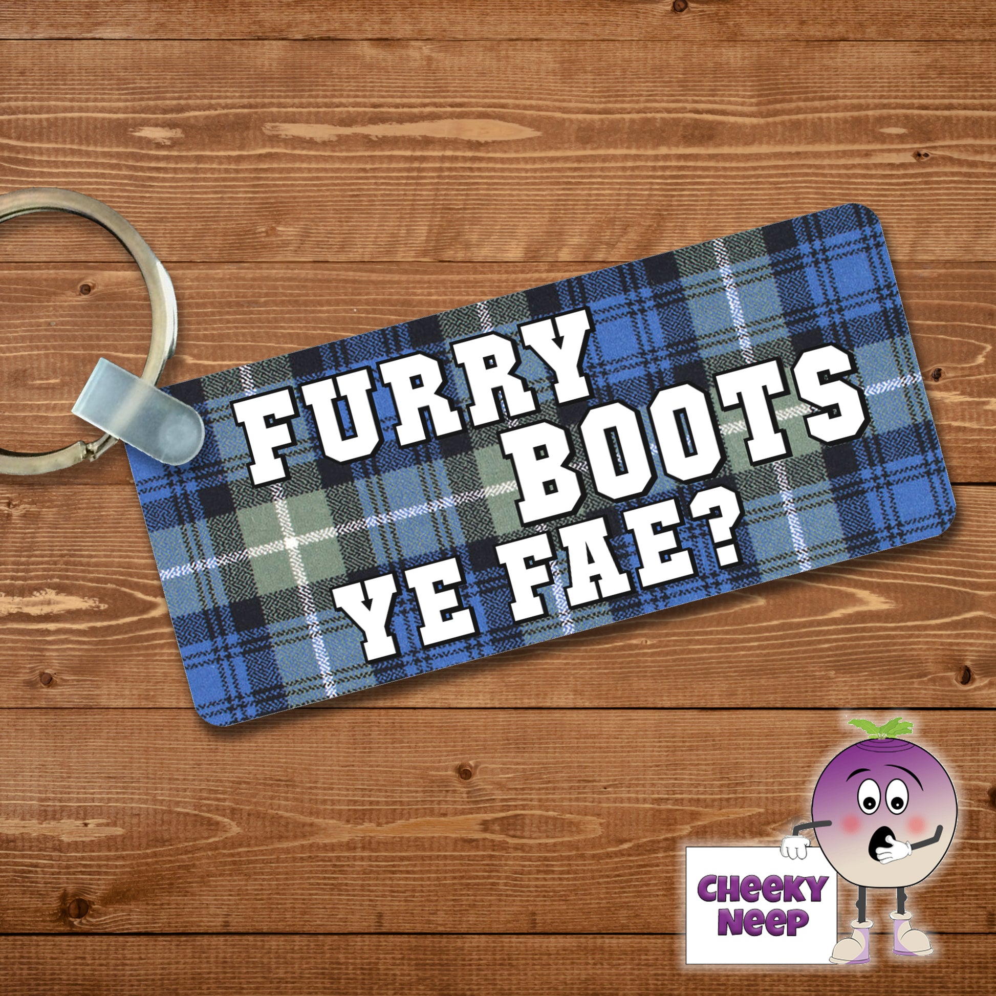 Rectangular plastic keyring with the words "Furry Boots Ye Fae?" printed in white on a tartan background on both sides.