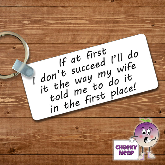 Rectangular plastic keyring with the words "If at first I don't succeed I'll do it the way my wife told me to do it in the first place!" printed on both sides.