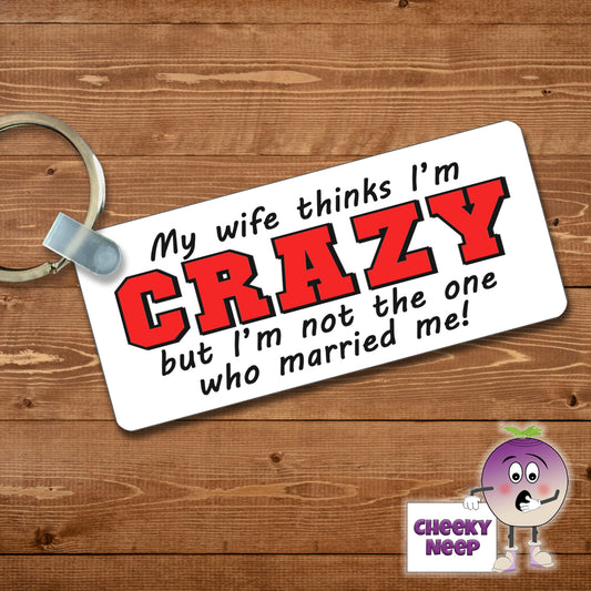 Rectangular plastic keyring with the words "My wife thinks I'm CRAY but I'm not the one who married me!" printed on both sides.