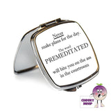 Square steel compact mirror with the words "Never make plans for the day. The word PREMEDITATED will bite you on the ass in the courtroom" printed on the front of the mirror.