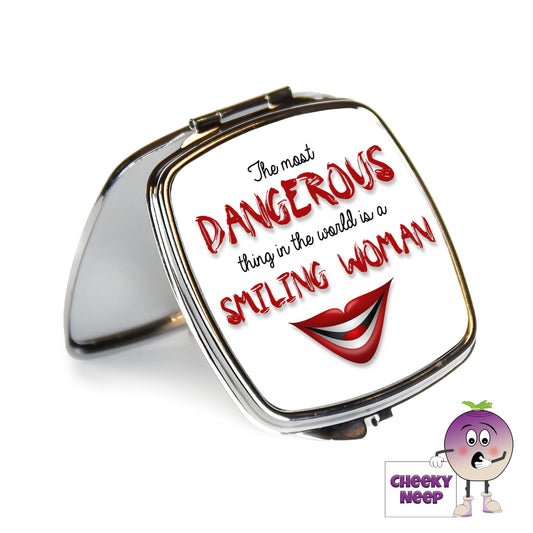 Square steel compact mirror with the words "The most DANGEROUS thing in the world is a SMILING WOMAN" printed on the front of the mirror.