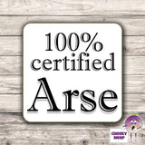 Square hardbacked coaster with the words "100% certified Arse" printed on it.