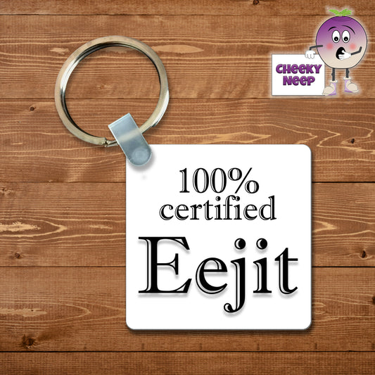 Square plastic keyring with the words "100% Eejit" printed on both sides.