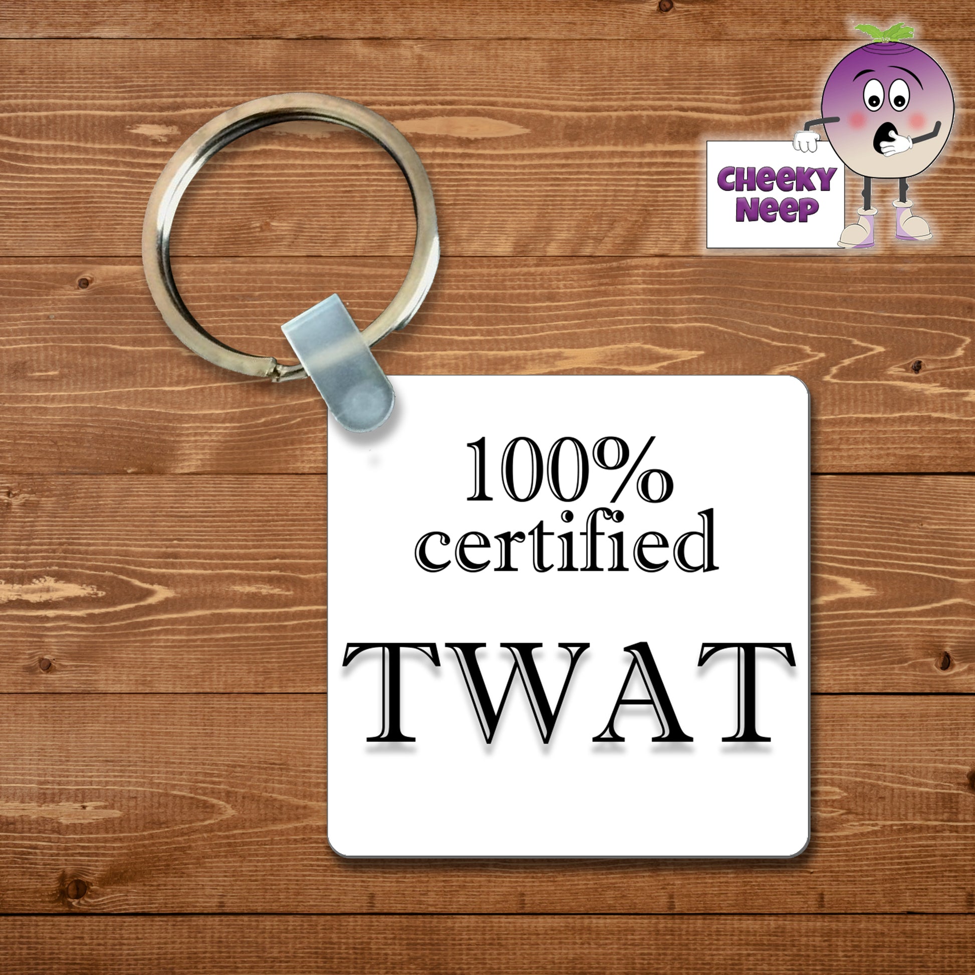 Square plastic keyring with the words "100% Certified Twat" printed on both sides.