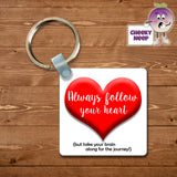 Square plastic keyring with the words "Always follow your heart (but take your brain along for the journey)" printed on both sides.