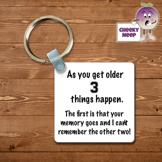 Square plastic keyring with the words "As you get older 3 things happen. The first is that your memory goes and I can't remember the other two!" printed on both sides.