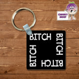 Black square keyring with the words "Bitch" printed four times on the keyring. As supplied by Cheekyneep.com