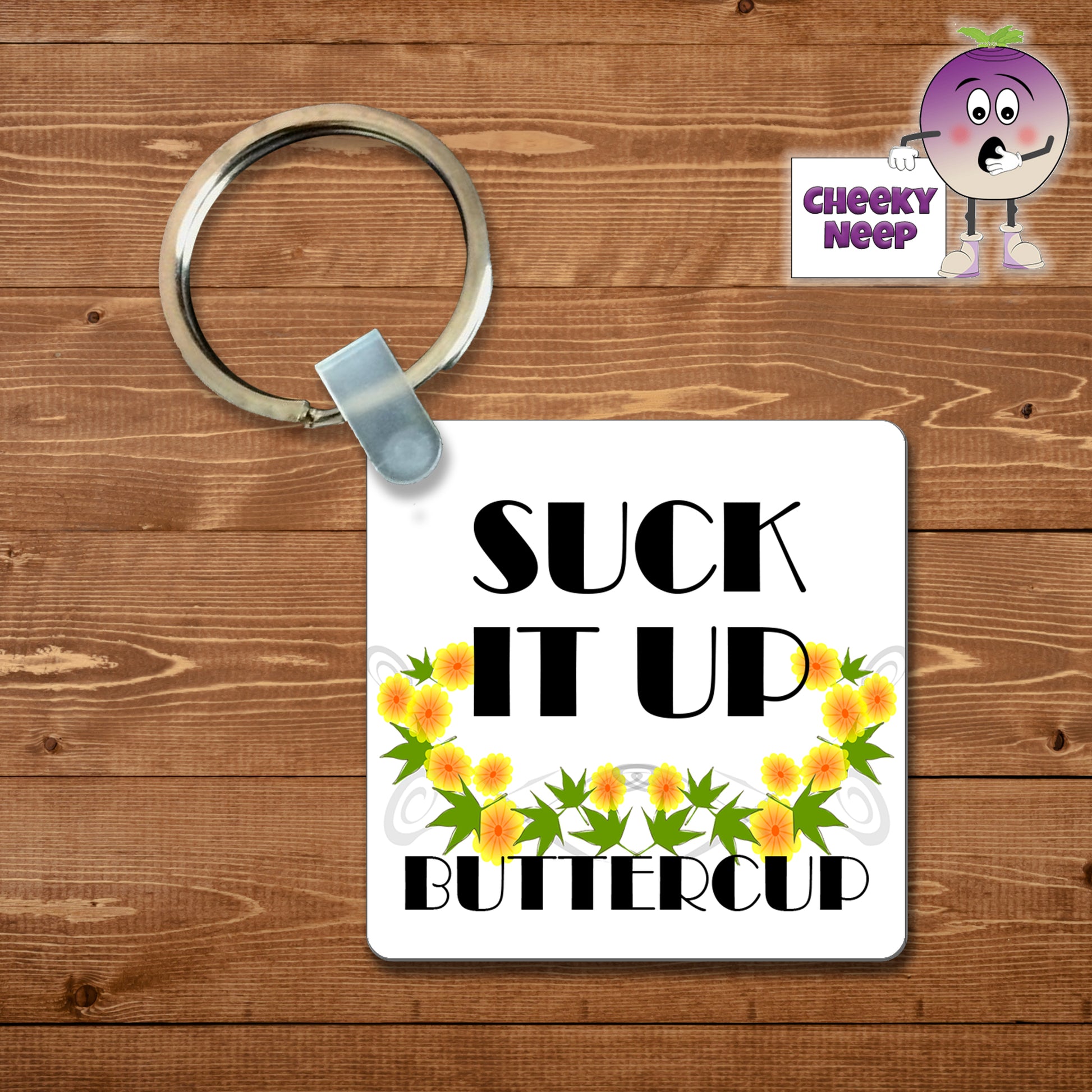 Square plastic keyring with the words "Suck it up Buttercup" printed on both sides.