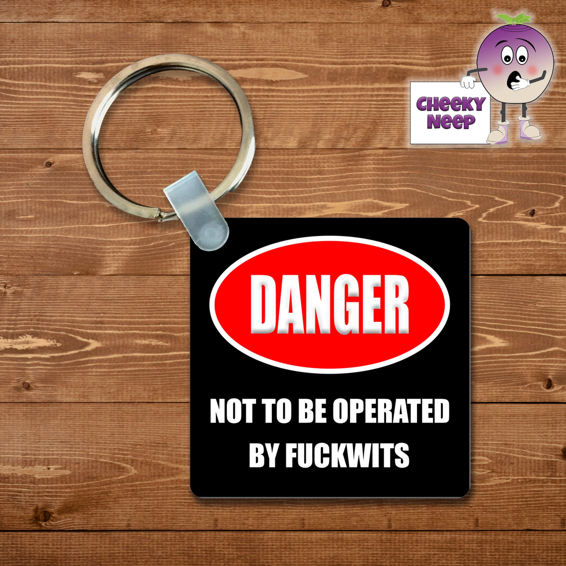 Black square keyring with the words "Danger. Not to be operated by Fuckwits"  printed on the keyring as supplied by Cheekyneep.com