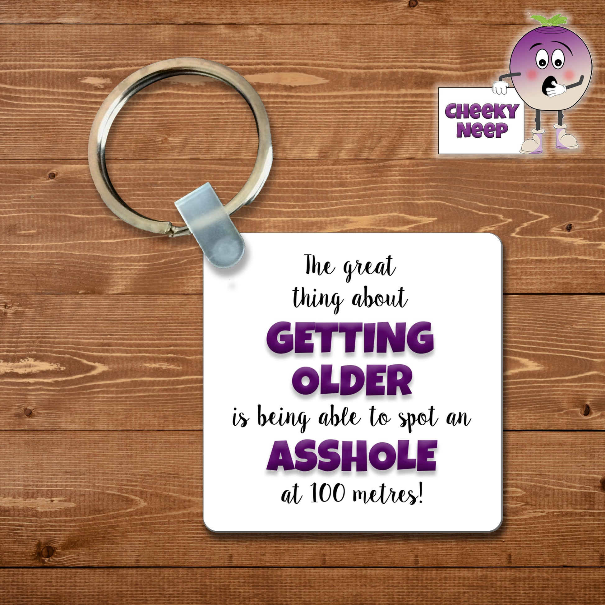 Square plastic keyring with the words "The great thing about GETTING OLDER is being able to spot an ASSHOLE at 100 metres!" printed on both sides.