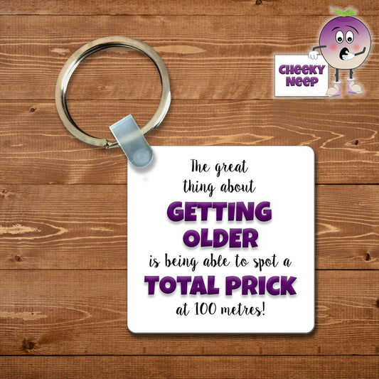 Square plastic keyring with the words "The great thing about GETTING OLDER is being able to spot a TOTAL PRICK at 100 metres!" printed on both sides.