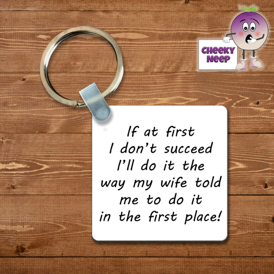 Square plastic keyring with the words "If at first I don't succeed I'll do it the way my wife told me to do it in the first place!" printed on both sides.