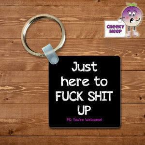 Black square keyring with "Just here to fuck things up. PS: You're Welcome!" printed on the keyring as supplied by Cheekyneep.com