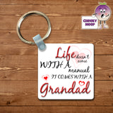Square keyring with the slogan "Life doesn't come with a manual it comes with a Grandad" and some love hearts printed on both sides of the keyring