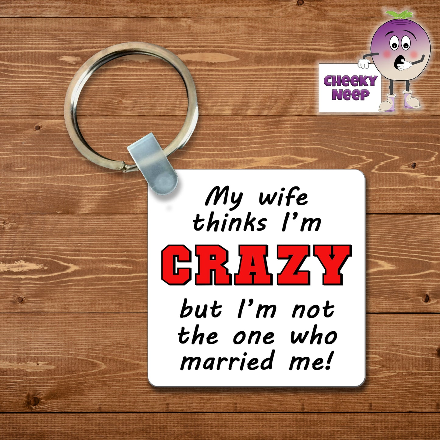 Square plastic keyring with the words "My wife thinks I'm CRAZY but I'm not the one who married me!" printed on both sides.