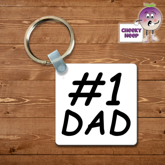 Square plastic keyring with the words "#1 Dad" printed on both sides.