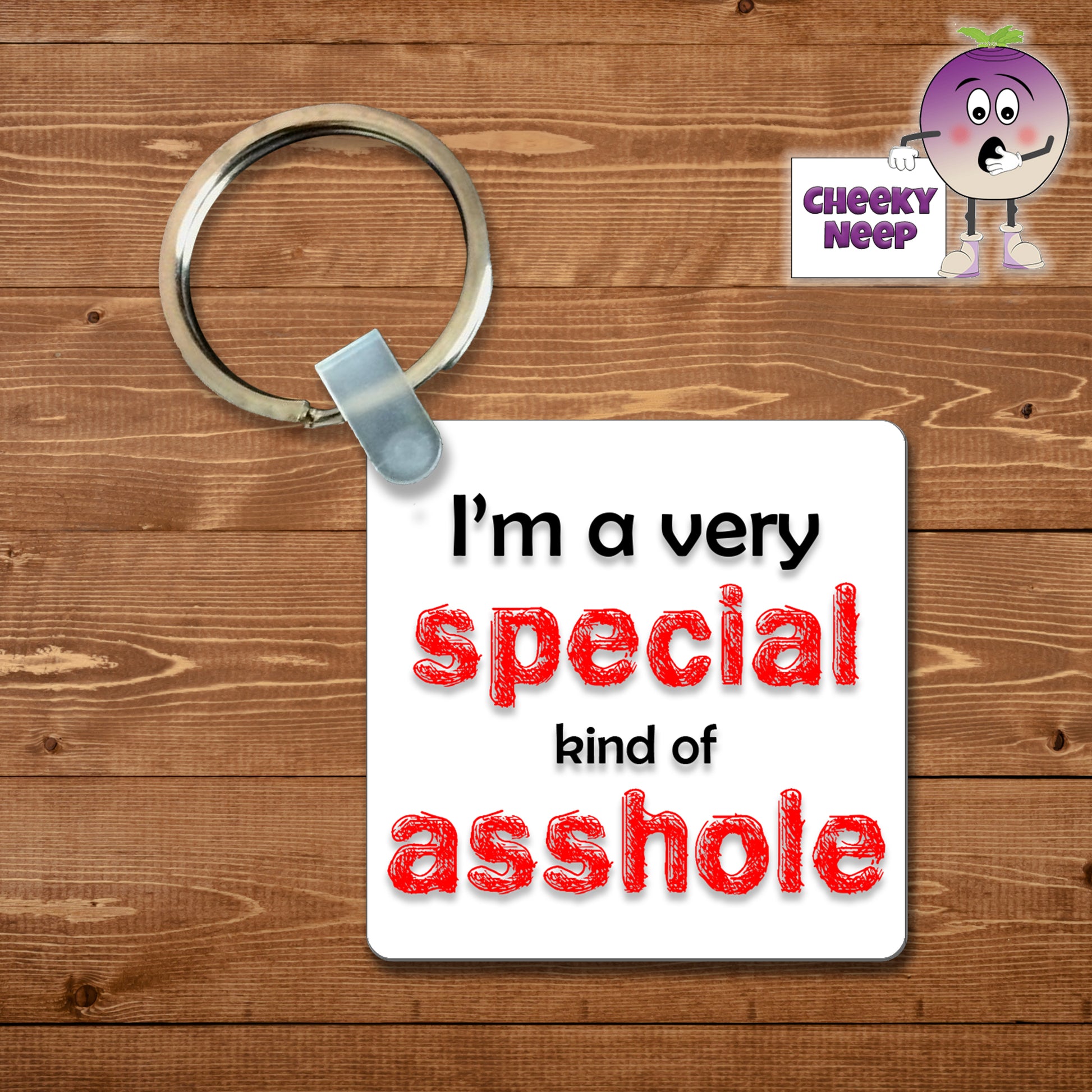 Square plastic keyring with the words "I'm a very special kind of asshole" printed on both sides.