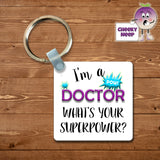 Square plastic keyring with the words "I'm a doctor what's your superpower?" printed on both sides.