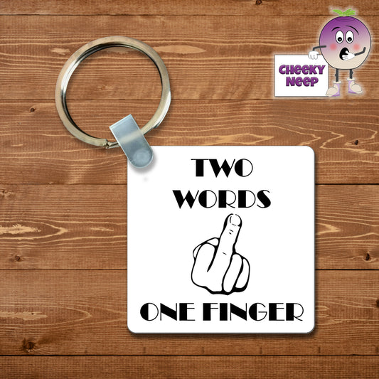 Square plastic keyring with the words "Two words one finger" printed on both sides together with a picture of a hand with the middle finger extended.