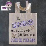 Tote Shopping bag in natural with the words "I'm RETIRED but still work full time as a PAIN IN THE ASS" printed on the bag