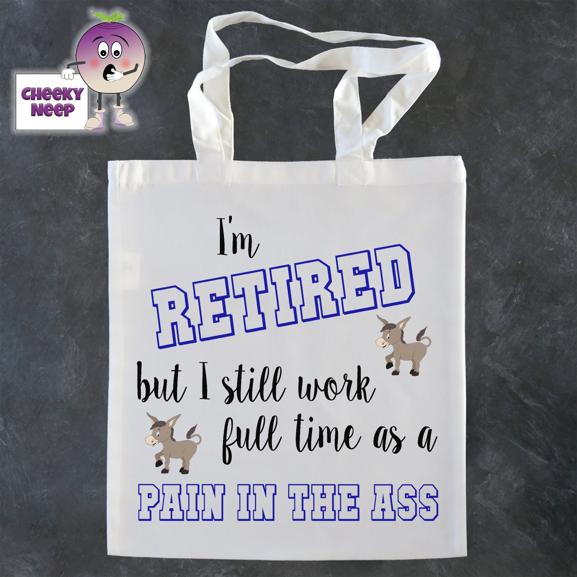 Tote Shopping bag in white with the words "I'm RETIRED but still work full time as a PAIN IN THE ASS" printed on the bag